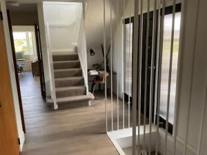 a hallway with a stair case and a stair case at Fletcher House Sleeps 18 Location Views in Taupo