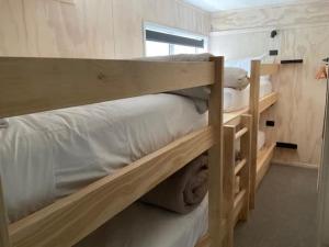 a couple of bunk beds in a room at Fletcher House Sleeps 18 Location Views in Taupo +40 photos