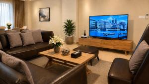a living room with a large flat screen tv at THE POOL LABONE in Accra