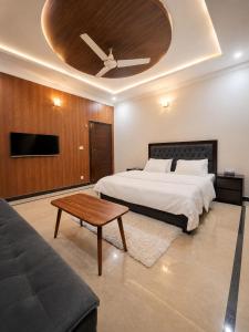 a bedroom with a bed and a ceiling at Willow House in Islamabad