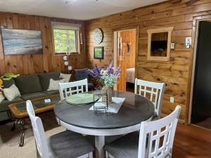 a dining room and living room with a table and chairs at Tracadie Cottages in York