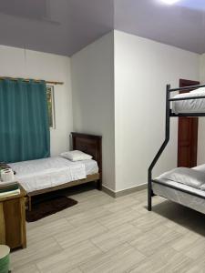 a room with two bunk beds and a table at Sisa Lodge in Tena +5 photos
