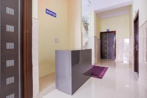 a hallway with a door with a purple object on the floor at Super Hotel O Viraj Deluxe Narela in Delhi