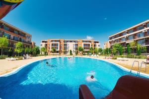 a large swimming pool with people in the water at Summer Dream, Nesebar Fort Club, Sunny Beach in Sunny Beach
