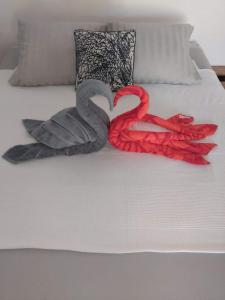 two swans made out of towels on a bed at Fare Zen Raiatea - with pool in Uturoa