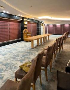 a conference room with a wooden table and chairs at Jawaher hotel in Karbala +2 photos