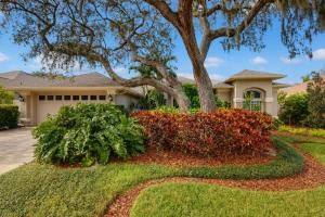 a house with a tree and flowers in front of it at The Riverview Estates in Riverview