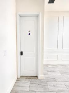 an empty white room with a white door at SpaceX R4 Shared in Orlando +24 photos