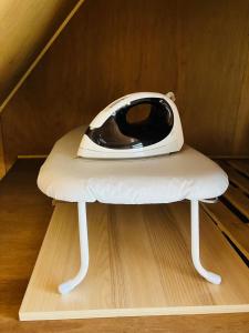 a white machine sitting on top of a stool at Joy House in Matsumoto