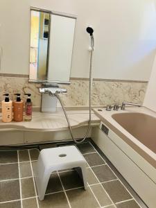a bathroom with a toilet and a sink and a tub at Joy House in Matsumoto +13 photos