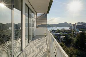 a balcony with a view of the water at Triple 888 Suites in Labuan Bajo