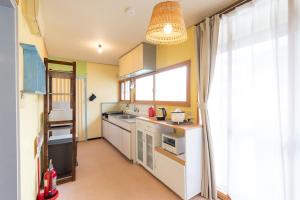 a small kitchen with a sink and a window at Joy House in Matsumoto