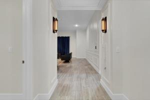 a hallway with white walls and wood floors at SpaceX R3 Shared in Orlando +23 photos