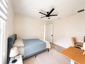 a bedroom with a bed and a ceiling fan at SpaceX R3 Shared in Orlando