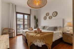 a bedroom with a large bed and a window at Casa Carpa Andalucia IV Carabeo Playa in Nerja