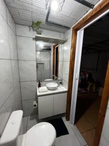 a bathroom with a toilet and a sink at Hostel e Pousada das Rosas Nova Hartz RS in Nova Hartz +9 photos