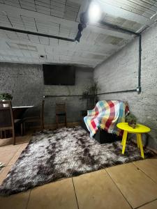 a living room with a couch and a table at Hostel e Pousada das Rosas Nova Hartz RS in Nova Hartz
