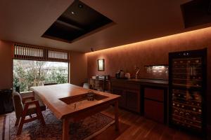 a kitchen with a table with a sink in it at みささ in Kyonan