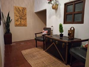 a living room with a table and a chair at Hotel Alma Divina in Villa de Leyva