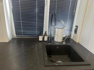 a kitchen counter with a sink and a window at Historical Apartments by Stepan Fedak in Lviv +19 photos
