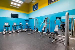a gym with a row of tread machines at Cozy ATL Retreat in Decatur