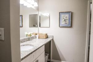 a bathroom with two sinks and a mirror at Cozy ATL Retreat in Decatur +17 photos
