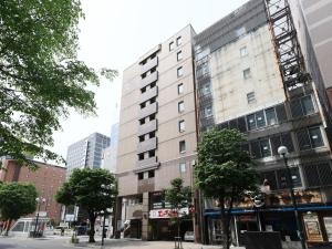 a tall white building on a city street at Tabist THE GREEN SAPPORO in Sapporo +79 photos