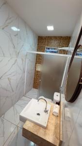 a bathroom with a white sink and a mirror at Hotel Vistta Iracema in Fortaleza +56 photos