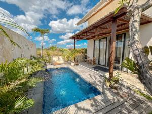 a swimming pool in the backyard of a house at Villa Umah Dangin Desa in Tanah Lot