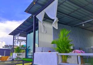 a patio with awning and a table and plants at วันเดย์ภูทับเบิก in Ban Maeo Thap Boek +16 photos
