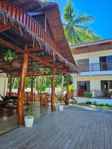 a pavilion with tables and chairs in a resort at Jungle Vibes Hostel in San Juan