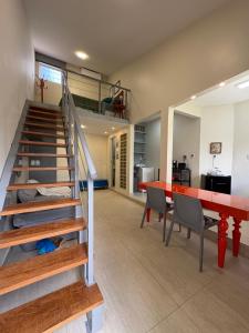 a living room with a staircase and a red table at Casa Loft 9C in São Luís