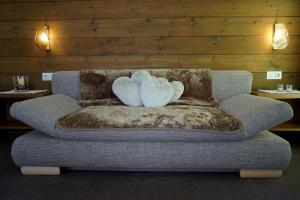 a couch with a stuffed animal on top of it at Apart Landhaus Zangerl in See