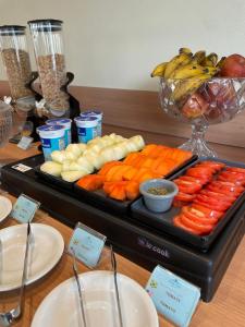a tray of carrots and other vegetables on a table at Beach Hotel Paúba in São Sebastião
