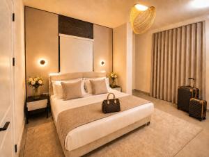 a bedroom with a large bed with a purse on it at Elite Residence in Accra