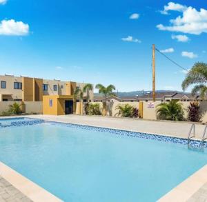 a swimming pool at the villas at disney springs resort at House of Harmony in Portmore