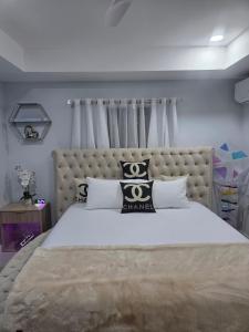 a bedroom with a large bed with black and white pillows at House of Harmony in Portmore +71 photos