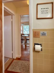 a hallway with a toilet paper dispenser in a house at Bluffton Breeze Cottage in Muskegon +82 photos