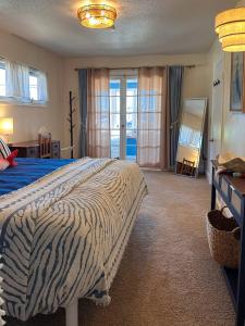 a bedroom with a bed with a zebra blanket at Bluffton Breeze Cottage in Muskegon