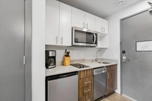 a kitchen with white cabinets and a microwave at Kasa Capitol Hill Seattle in Seattle +39 photos