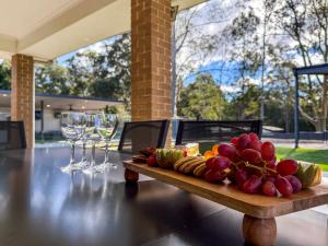 a table with wine glasses and a tray of food at Wrenwood in Abernethy