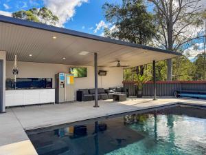 a house with a swimming pool and a pavilion at Wrenwood in Abernethy