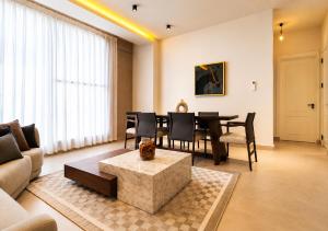 a living room with a dining room table and chairs at Elite Residence in Accra