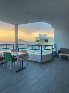 a balcony with a table and chairs on a ship at Dar Hachemia in Ras El Ma
