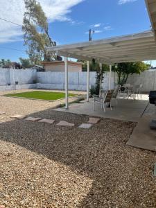 a pavilion with a table and chairs in a yard at West Mitchell in Phoenix