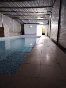 an empty swimming pool in a building at Coney Camping in Ambato