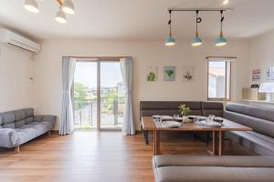 a living room with a couch and a table at Fujiyama Stay in Fujinomiya