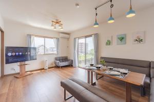 a living room with a couch and a table at Fujiyama Stay in Fujinomiya