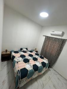 a bedroom with a bed and a air conditioner at Villa José in Sindia