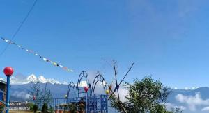a view of the snow capped mountains from a playground at Hotel Shangbola in Pāti Bhanjyāng +5 photos